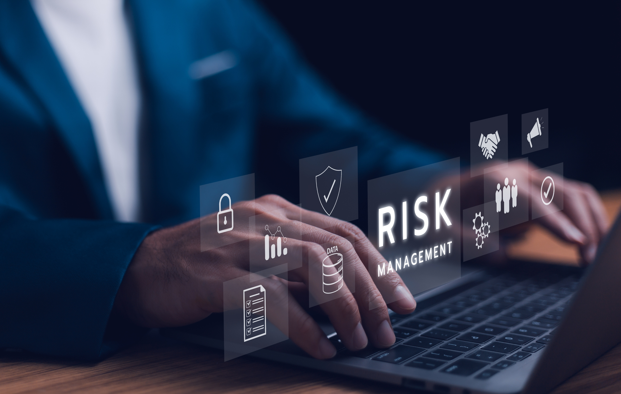 person at computer looking at risk management items