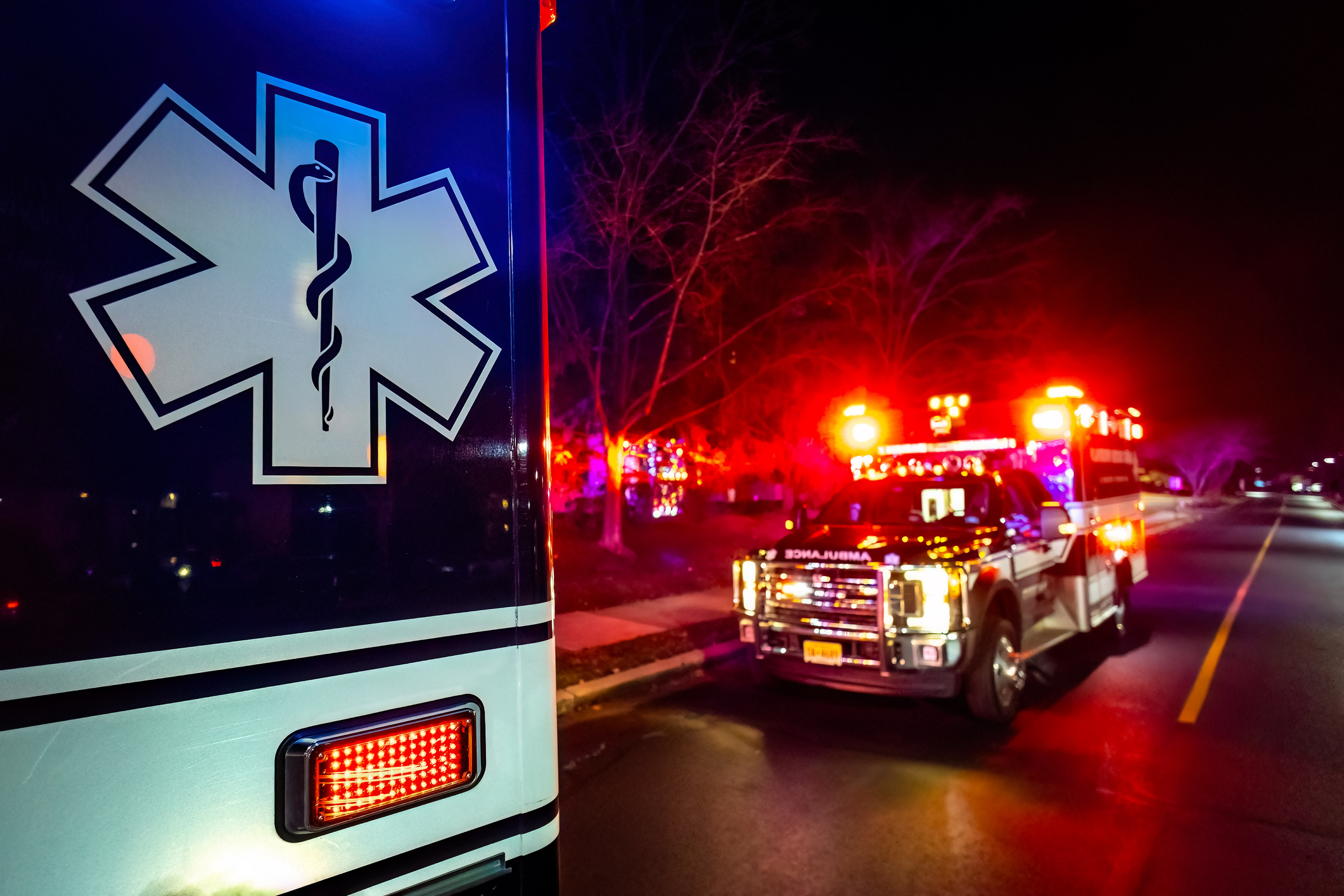 Close up emergency ambulance truck illuminated at night accident response
